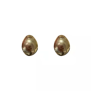 Minimalist polished gold brass oval hoop earrings with a heavy glossy metallic finish