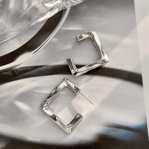 Polished silver geometric square twisted earrings with a minimalist 14K brass aesthetic