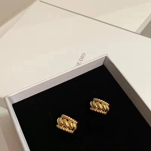 Classic gold twisted weave C-shaped hoop earrings presented in a luxury jewelry box