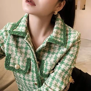 Classic green and white tweed jacket with woven trim and gold buttons for women