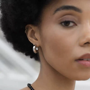 Polished silver chunky hoop earrings for women featuring a minimalist thick ring design