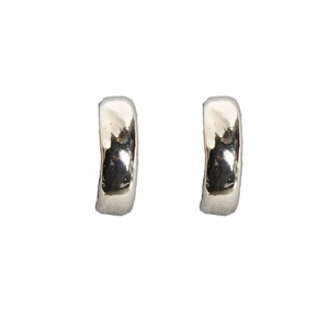 Close-up of silver-tone hammered texture hoop earrings with polished reflective surface