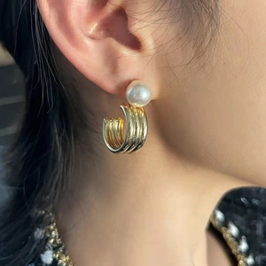 Elegant C-shaped gold hoop earrings with white round pearl stud for stylish women