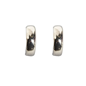 Classic silver-plated thick hoop earrings with organic hammered texture on white background