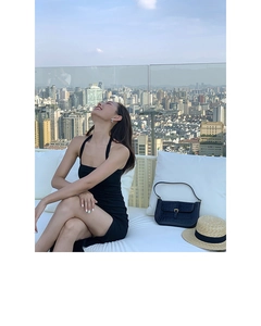 Chic butterfly zircon stud earrings paired with a black halter dress in an urban setting