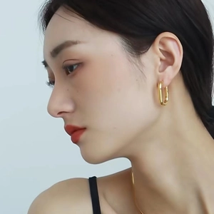 Elegant 14K gold plated brass U-shaped geometric earrings on a female model