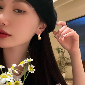 Elegant 14K gold-plated brass lantern earrings with shell texture on model