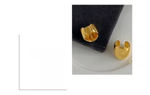 Detail showing high-polish gold finish on C-shaped metal ear cuffs for women