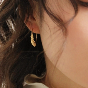 French luxury brass wheat ear hook earrings in 18K gold plating worn by a female model