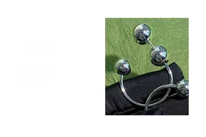 Macro shot of silver mirror-finish metal spheres on black velvet with green texture