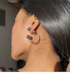 Silver ball hoop earring shown on ear from side view for minimalist styling