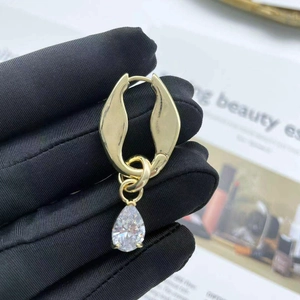 Elegant gold drop earrings with large teardrop zircon pendant and polished metal hoop