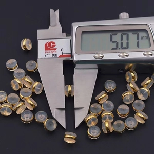 Detailed macro view showing the 5mm diameter of gold-plated silicone earring back stoppers