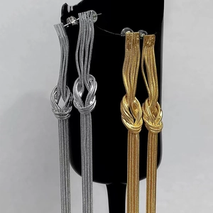 Elegant gold and silver metallic knot chain tassel earrings for a modern commuter style