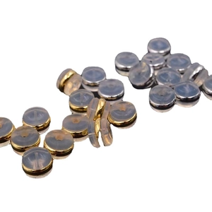 Golden and steel finish silicone earring backs with metal core on white background