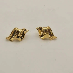 Detailed view of 18K gold-plated earrings with irregular polished wave and ribbon folds