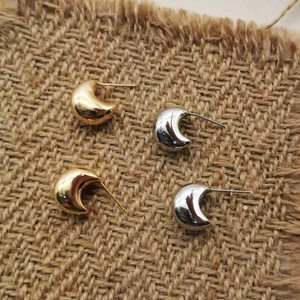 Minimalist C-shaped crescent stud earrings set in polished gold and silver finish