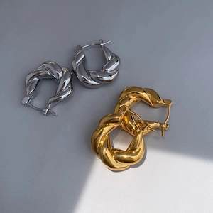 Boucles d'oreilles créoles torsadées vintage en finition or et argent poli