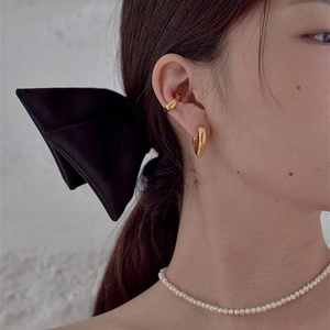 Minimalist gold heart earrings and ear cuff set shown on model for elegant styling