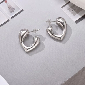Elegant geometric heart-shaped silver earrings with a high-polished metallic finish