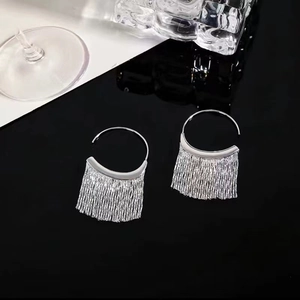 Elegant silver tassel hook earrings featuring liquid metal fringe on a luxury black background