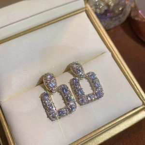 Square 925 silver needle drop earrings with micro-set zircons in a jewelry box