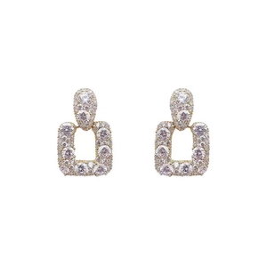 Luxe gold-plated geometric earrings with shimmering pavé zircon stones on white backdrop
