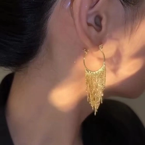 Elegant gold metal tassel hoop earrings with layered dangling chains for a luxury look