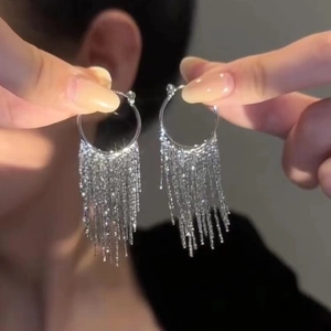 Elegant silver metal tassel hoop earrings featuring long delicate fringe chains