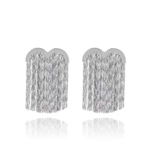 Elegant silver tassel drop earrings with wavy metal top on a clean white background