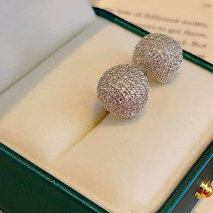 Elegant sparkling full pave zircon ball hoop earrings on a vintage green jewelry gift box