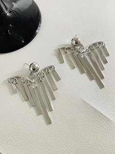 Detail view of silver fringe drop earrings with sleek fan-shaped metallic tassels