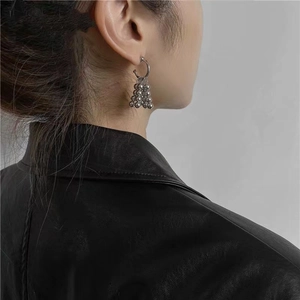 Minimalist silver grape cluster bead earrings on a model with black leather jacket