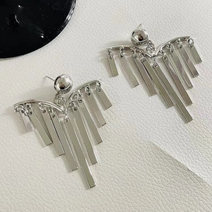 Chic silver long tassel pine needle earrings with geometric metal fringes on white leather