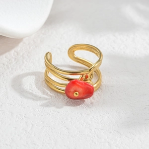 Detail of gold multilayer ring with red stone and adjustable open band design