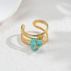 Detailed macro view of a gold plated adjustable ring with a heart-shaped turquoise stone