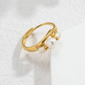 Detailed macro view of French vintage gold open ring with three central pearls