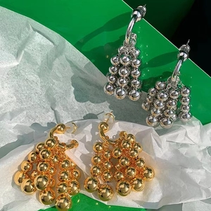 Golden and silver beaded cluster drop earrings in a minimalist metallic grape design
