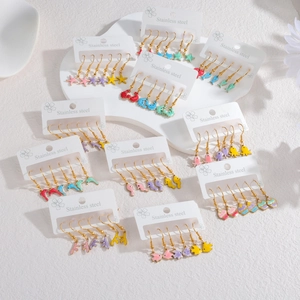 Colorful marine sea life charm earrings set in stainless steel displayed on white cards