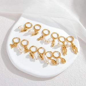 Golden ocean series earrings set with freshwater pearls and marine charms on display