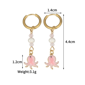 Macro shot of octopus drop earrings with size specs and artificial pearl details
