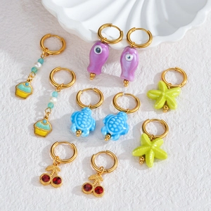 Golden titanium steel earring set with colorful turtle fish and cherry charms on white shells