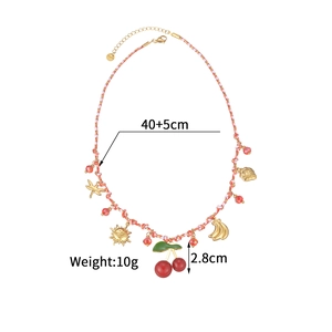 Detail of colorful woven necklace with fruit charms and stainless steel lobster clasp