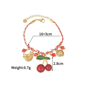 Detail view of woven colorful bracelet with fruit charms and 16+3cm measurement label