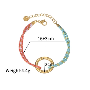 Detail of handmade braided cord bracelet with gold metal ring and lobster clasp