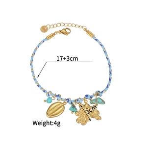 Detail of woven rope bracelet with gold shell, octopus charms and turquoise stones