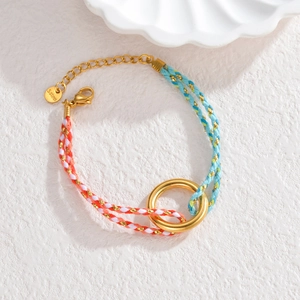 Colorful woven stainless steel bracelet with golden ring pendant and lobster clasp detail