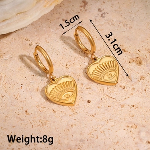 Detail shot of vintage gold heart earrings with evil eye motif showing 3.1cm length