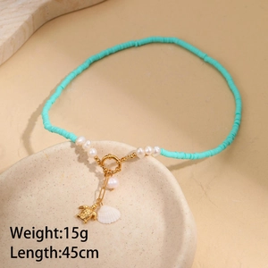 Detail of beach ocean style necklace with turquoise beads, sea turtle and pearl pendant