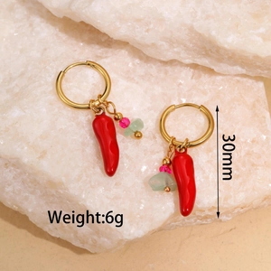 Detail shot of a 30mm gold hoop earring with red chili pendant and pink bead ornaments